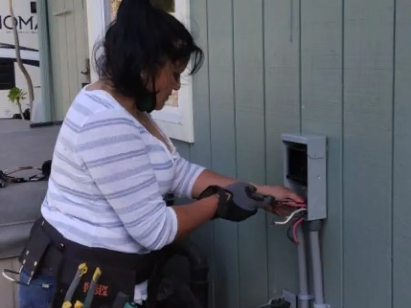 Licensed electrician wiring an exterior subpanel in West Vero Corridor